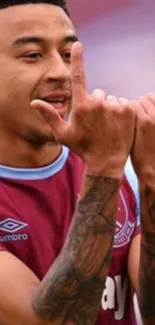 Exciting soccer player celebrating a goal on the field with a vibrant team jersey.