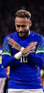 Soccer player celebrating in blue jersey on field.