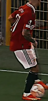 Soccer player in red jersey on the field.