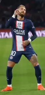 Soccer player posing energetically on field.