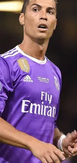 Soccer player in purple jersey striking a pose on the field.