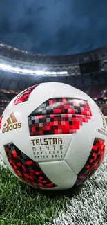 Close-up of a soccer ball on a stadium field under bright lights.