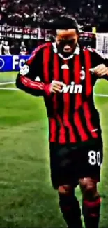 Soccer player in red and black jersey on the field, mid-action wallpaper.