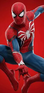 Dynamic Spider-Man action pose on red background.