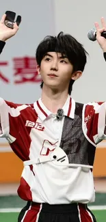 Young sports enthusiast in action wearing a team jersey and holding a microphone.