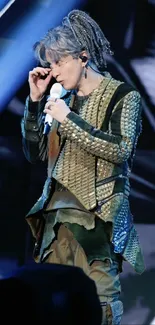 Dynamic performer on stage in olive green attire.