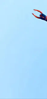 Superhero flying in bright blue sky.