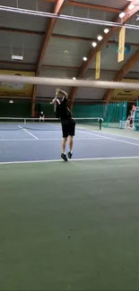 Dynamic tennis serve on indoor court wallpaper.