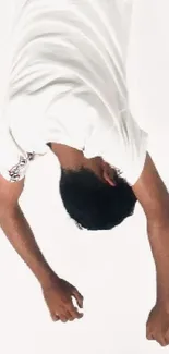 Upside down portrait of a person in a white shirt.