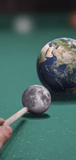 Earth and Moon as billiard balls, teal background.