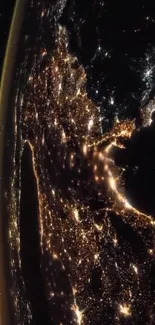 A stunning view of Earth at night from space, glowing with city lights.