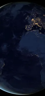 Earth viewed from space at night, showcasing glowing city lights and continents.