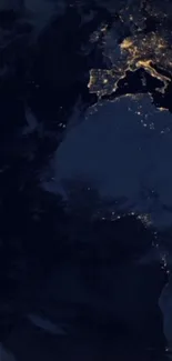 Earth at night with glowing lights, seen from space.