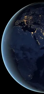 Earth viewed from space at night, showing city lights.