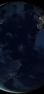 Dark view of Earth with glowing city lights from space.