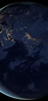 Earth at night from space showing glowing city lights.