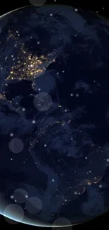 Earth at night seen from space with glowing city lights against a dark blue sky.