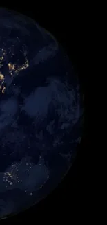 Earth at night with illuminated continents on a dark space background.