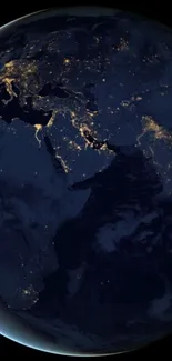 Earth viewed from space at night with glowing city lights.