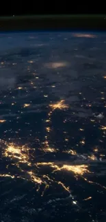 Night view of Earth's illuminated cities from space, showcasing bright lights.