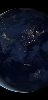 Earth illuminated by city lights as seen from space at night.