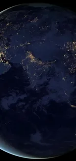 Satellite view of Earth illuminated by city lights at night.