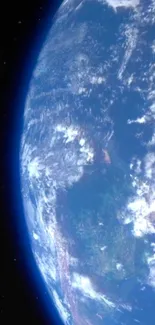 View of Earth from space with deep blue hues and cosmic backdrop.