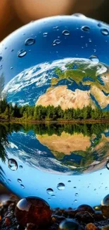 Earth reflected in large water droplet on nature background.