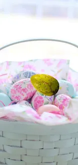 Pastel Easter basket with colorful decorated eggs.