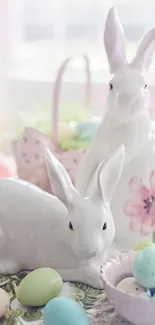 Ceramic Easter bunnies with pastel eggs on a spring-themed table.