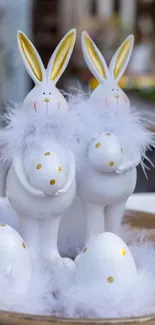 Easter bunnies with eggs and feathers on a decorative plate.