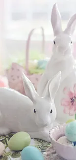 Ceramic bunny figurines with pastel Easter eggs and flowers.