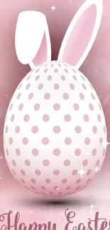 Easter egg with bunny ears on a pink background.