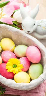 Colorful Easter eggs with ceramic bunny and spring flowers on wooden table.