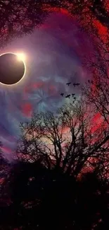 Solar eclipse with vibrant red sky and silhouetted trees.