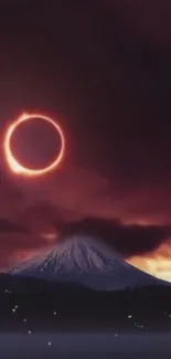 Eclipse over a snow-capped mountain with a darkened sky.