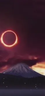 Mobile wallpaper featuring an eclipse over a mountain with a dark purple sky.