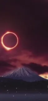 Solar eclipse over a mountain at night with dark purple sky.