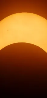 Vibrant mobile wallpaper of a solar eclipse with a distinct sun and moon alignment silhouette.