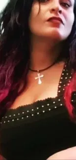 Edgy woman with dark attire and cross necklace, fashion-forward style.