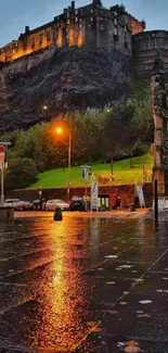 Edinburgh Castle lit at night with wet streets reflecting lights.