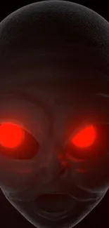 Close-up of alien face with glowing red eyes on a dark background.