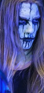 Intense face paint with blue accents and expressive features.