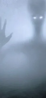 Eerie silhouette with glowing eyes in foggy atmosphere.