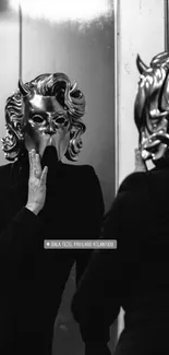 Person in devil mask looks at mirror reflection, black and white photo.