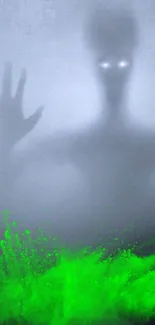 Eerie foggy wallpaper with glowing green hands.