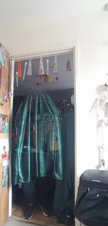 Eerie room with skeleton decor and teal drapery.