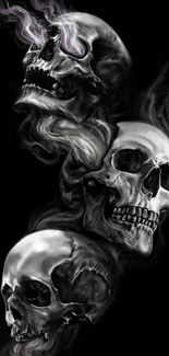 Eerie skulls emanating smoke on a black background wallpaper.