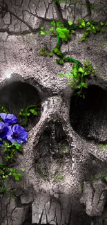 Eerie skull with purple flowers and green leaves on a cracked stone surface.