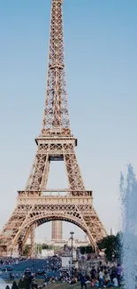 Eiffel Tower against a bright blue sky.